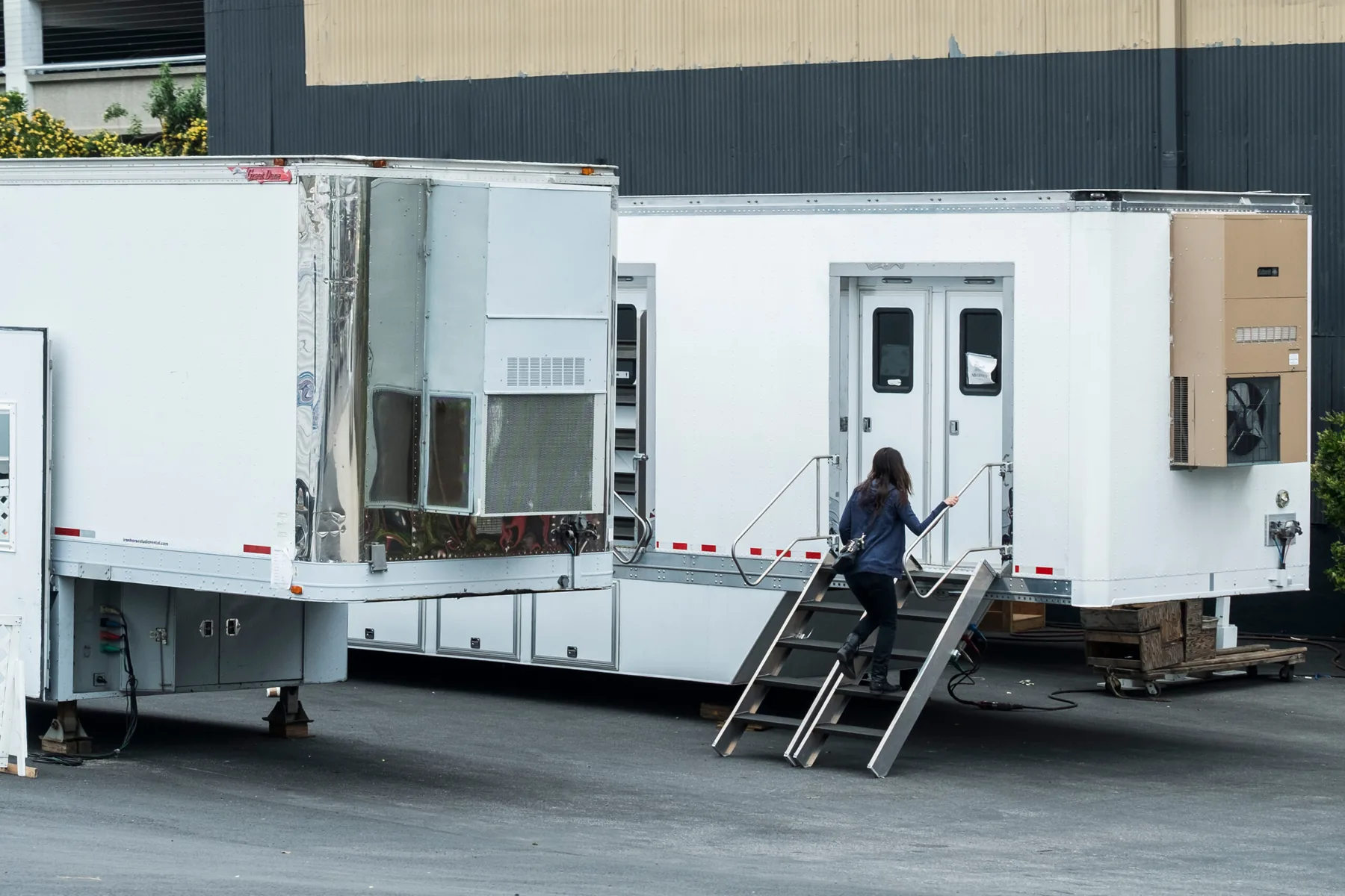 Crew member entering a production trailer