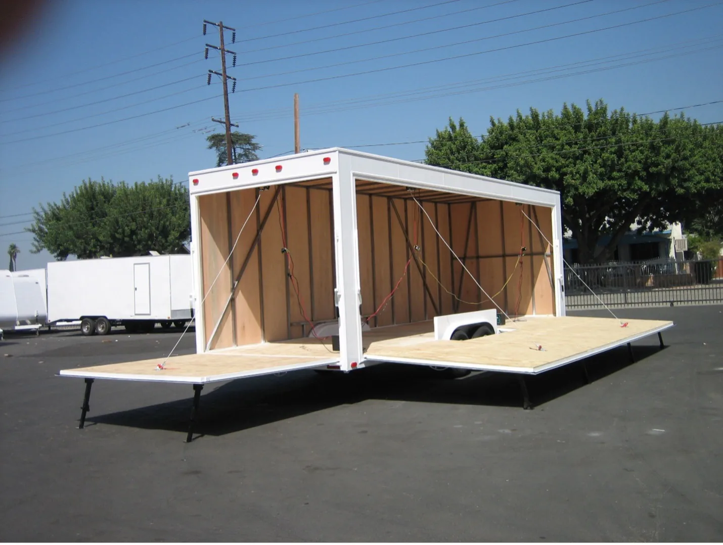 Drop-down side wall trailer opened for customer access