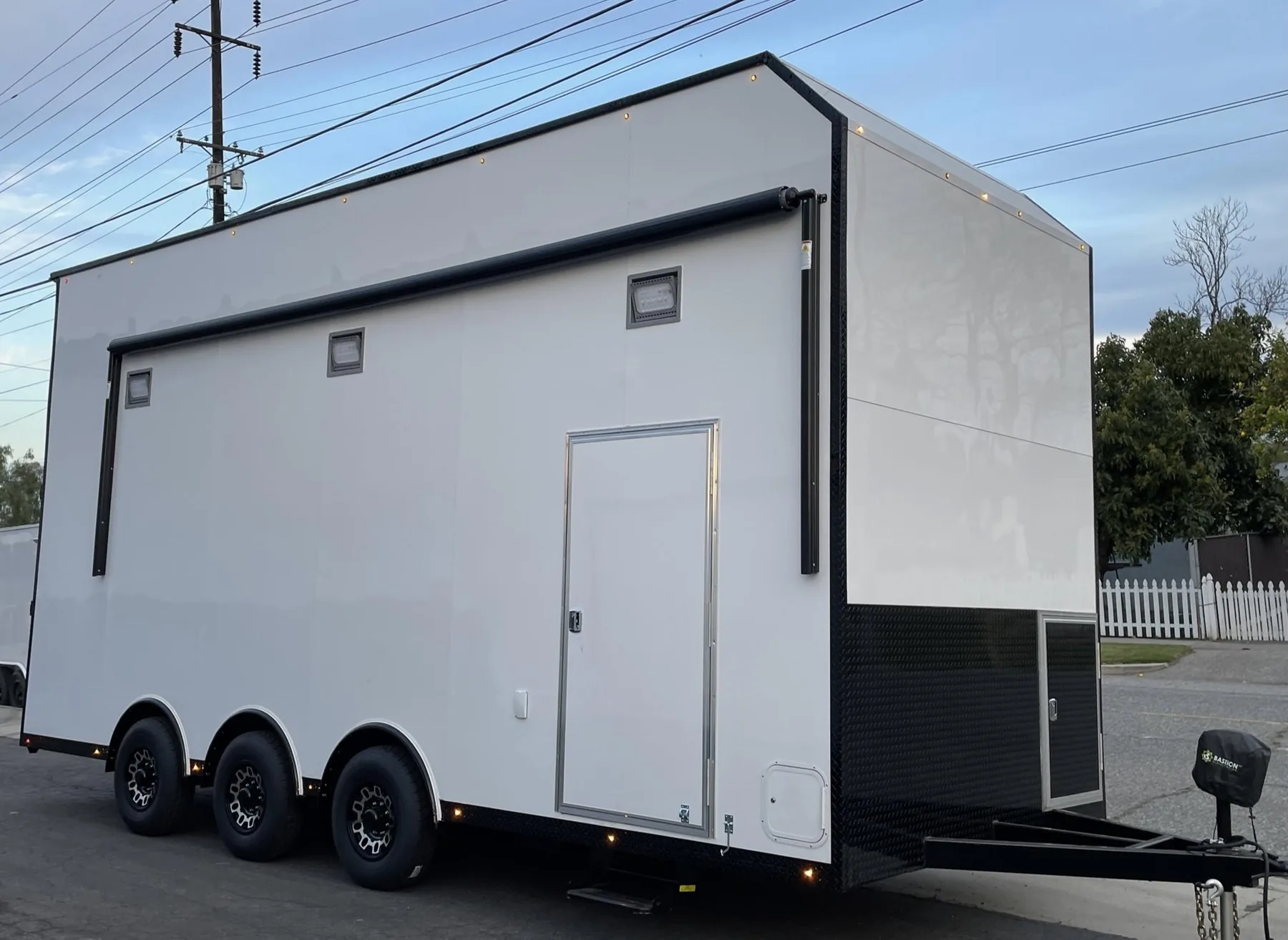 White triple-axle stacker trailer